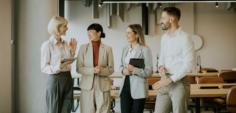 Business team discusses ideas in modern office space during daylight hours