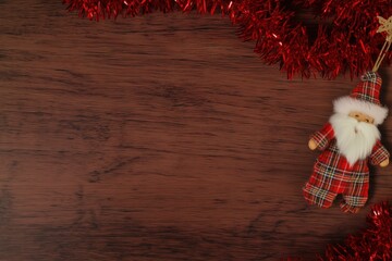 Wooden Christmas Background with Santa Ornament and Red Garland