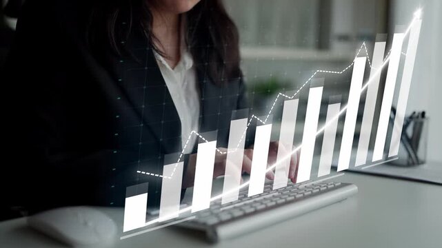 Business professional reviews financial data on a sleek computer, showcasing a digital graph that highlights market growth trends and insights in a modern workspace. Copula