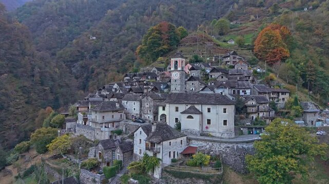 Historic village of Corippo, Ticino, surrounded by lush Swiss valley.