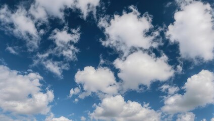 Fototapeta premium A vast, bright blue sky filled with fluffy white clouds, creating a serene and airy landscape