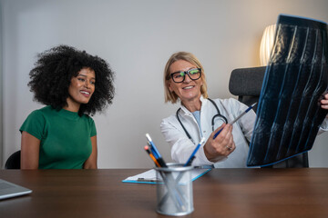Doctor and patient looking at x-ray or MRI concept healthcare
