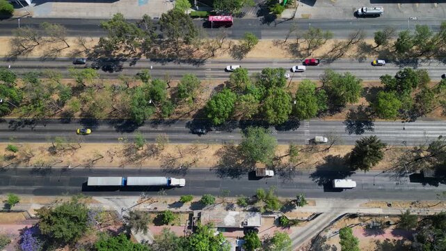 Aerial vertical shot showing traffic flow on Lazaro Cardenas Avenue with trees and road lanes