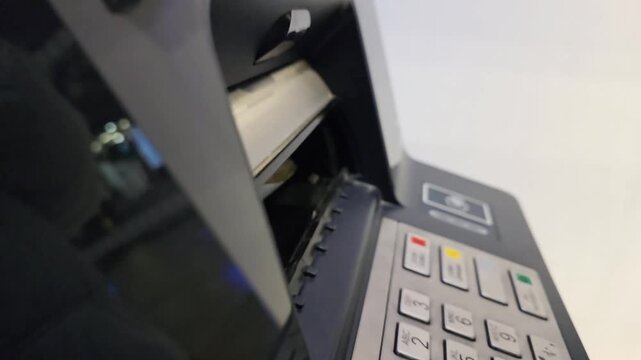 ATM dispensing cash through money slot during banking transaction. Close-up of automated teller machine releasing banknotes, concept of withdrawal, personal finance, electronic banking and modern paym
