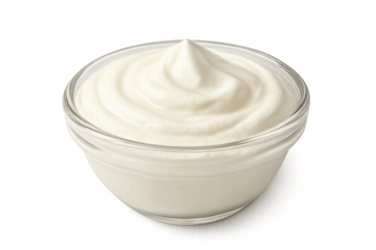 Glass bowl holding a swirl of creamy white sauce, like sour cream, yogurt, or mayonnaise. Food ingredient and condiment