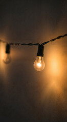 Decorative string lights glowing softly against a dark background  
