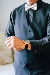 businessman holding a watch