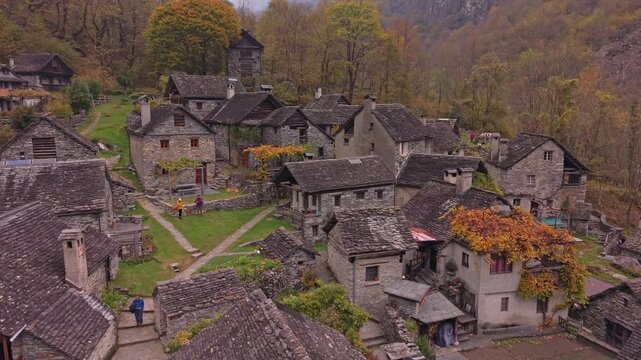Aerial shot of Foroglio village glowing with autumn shades, Ticino.