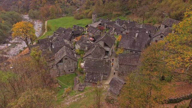 Historic Foroglio nestled in a fall-colored valley, aerial view, Ticino.