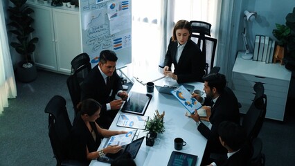 Top view of female leader looking financial statistic at business meeting. Professional marketing team looking and analyzing stock market investment graph and planning strategy. Teamwork. Directorate.