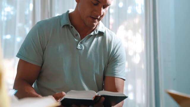 Top down view of prayers reading bible with cross on the laps while making folded hands. Aerial view of diverse people praying to god with faith, trust and hope. and sitting in circle. Symposium.