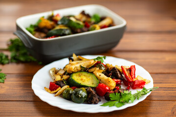Colorful baked vegetable dish with mushrooms and zucchini slices
