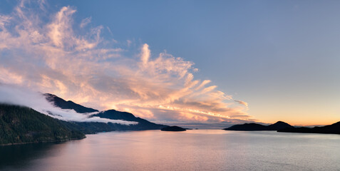 Sunset Over Calm BC Coastline With Islands And Misty Mountains In Canada