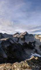 Alpine Mountain Range Panorama in British Columbia, Canada With Jagged Peaks and Snow Fields Under Sky