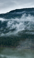 Fototapeta premium Misty Forest Ridge Over Foggy Mountain Valley in British Columbia, Canada