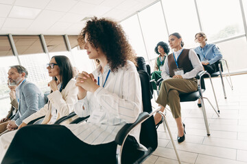 Diverse group of professionals attending a business conference in a modern office setting to gain...