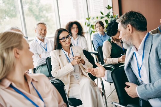 Group of diverse professionals in a meeting environment discussing ideas and collaborating in teamwork at an office space