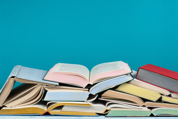 Open book, hardback colorful books on wooden table. Back to school. Copy space for text. Education business concept.