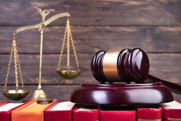 Law concept - Open law book, Judge's gavel, scales, Themis statue on table in a courtroom or law...