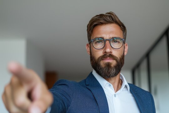 Businessman pointing at upward arrow graph office environment motivational concept professional viewpoint - Powered by Adobe