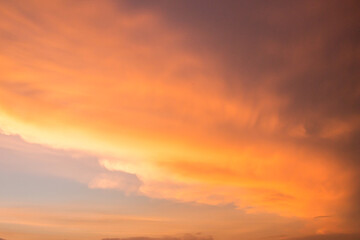 Fototapeta premium Dramatic thick cloud band with orange, yellow sky tones