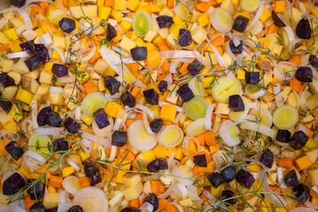 Mix of diced and seasoned autumn vegetables, ready to be roasted in the oven