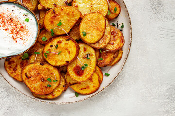 Crispy potato slices, with parmesan cheese and spices, fried in the oven, homemade, no people,