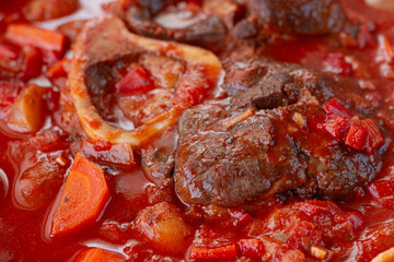 ossobuco stew with vegetables, knuckle on the bone with new potatoes, in tomato sauce,homemade, top view, no people,