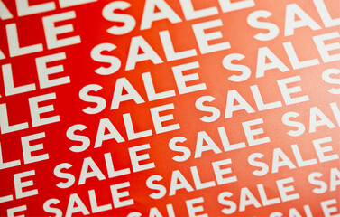 Repeating White 'SALE' Text on a Bright Red Background in a Diagonal Pattern