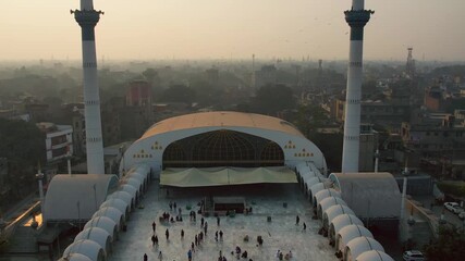 Lahore, Pakistan - 29 July 2025: Aerial view of the Data Darbar mosque, with its tall minarets standing out against the backdrop of the cityscape.