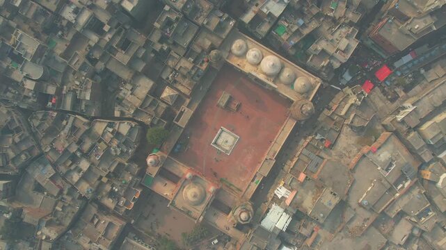 Aerial view of the Wazir Khan Mosque, a historic Mughal-era mosque with intricate tile work and domes, Lahore, Punjab, Pakistan.