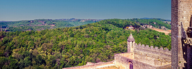 Panoramic view of the stone ramparts and surrounding countryside of a castle in Dordogne