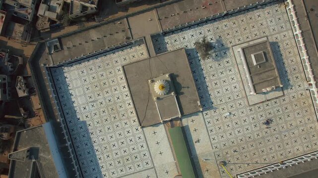 Aerial view of Gurdwara Janam Asthan, the birthplace of Guru Nanak, with its intricate geometric patterns contrasting against the surrounding buildings, Nankana Sahib, Punjab, Pakistan.