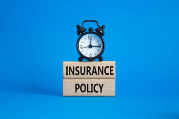Insurance Policy symbol. Concept word Insurance Policy on wooden blocks. Beautiful blue background. Business and Insurance Policy concept. Copy space