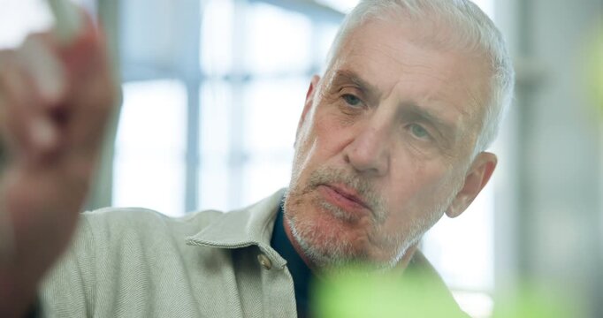 Writing, planning and talking with business man in office for brainstorming, scrum and schedule agenda. Collaboration, project timeline and glass wall with mature employee in agency for meeting