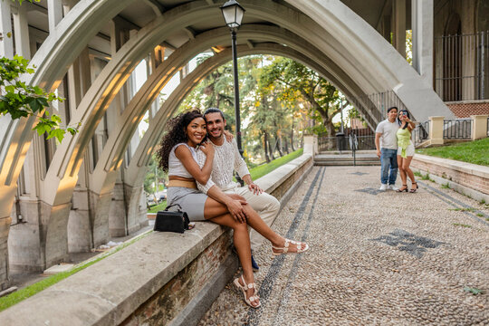 Happy couple enjoying urban architecture and green park
