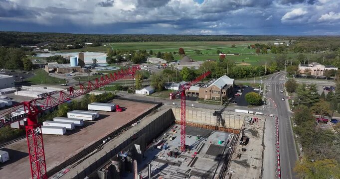 Aerial view of a vibrant construction site with a prominent red crane and ongoing construction contrasting with the surrounding buildings, Middletown, Ohio, United States.