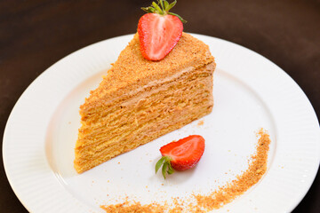 Slice of layered honey cake Russian Medovik. Delicious homemade dessert.