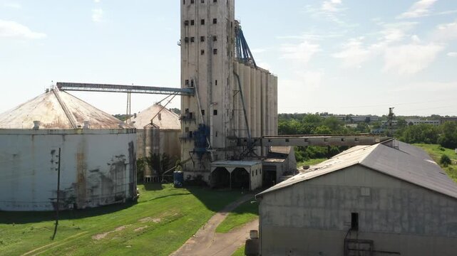 Cincinnati, United States - 02 August 2025: Aerial view of aged grain elevators with connecting metal walkways under a partly cloudy sky on E Sharon Rd.
