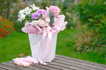 Bunch of flowers with a chocolate bar in the garden