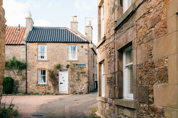 Charming old stone buildings along a narrow quiet street in a traditional village setting