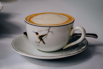 Cappuccino in Decorative Hummingbird Teacup on Saucer