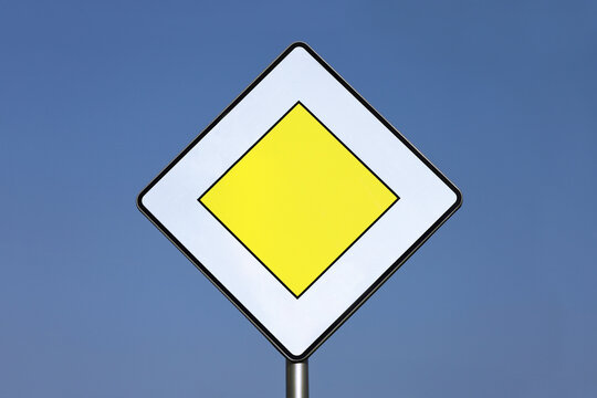 "Priority road" road sign on a blue sky background.