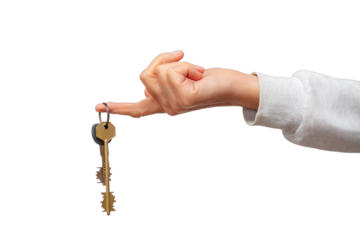 New homeowner celebrating with keys to their house in a bright setting