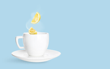 Citrus drink for health boosting. Lemon pieces falling into cup on light blue background. Cold season remedy