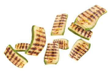 Grilled pieces of zucchini flying in air on white background