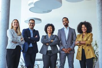 Diverse Team Of Professionals Standing Together In Modern Office For Business Collaboration