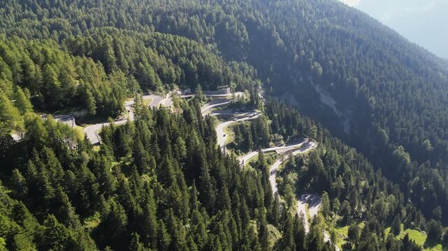 Aerial view of Maloja Pass road in the Swiss Alps. Mountain serpentine road, with beautiful landscapes of European nature.