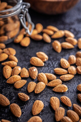 Almond kernel nuts on black table.