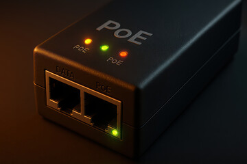Obraz premium Power over Ethernet injector close up with glowing indicator lights showing data and power connection status in dark setting